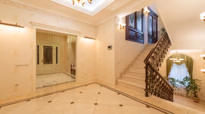 Elegant luxury home interior with a grand staircase and custom architectural detailing
