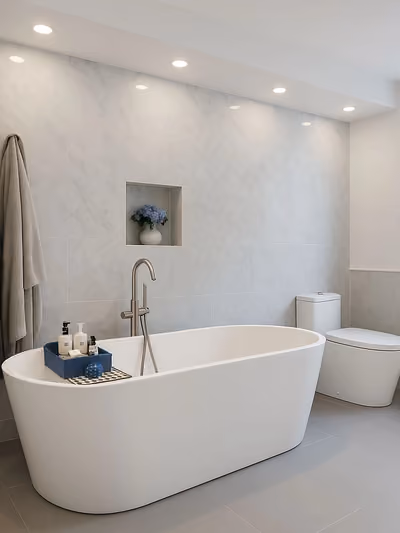 Bright modern bathroom with a freestanding soaking tub and marble-tile accent wall