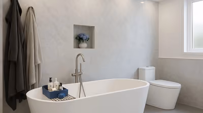 Bright renovated bathroom with a freestanding tub and marble-look tile