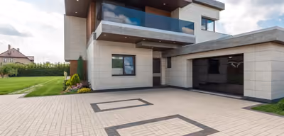 Newly completed custom home exterior with stone and timber accents under a Montana sky