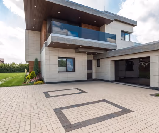 Newly completed custom home exterior with stone and timber accents under a Montana sky