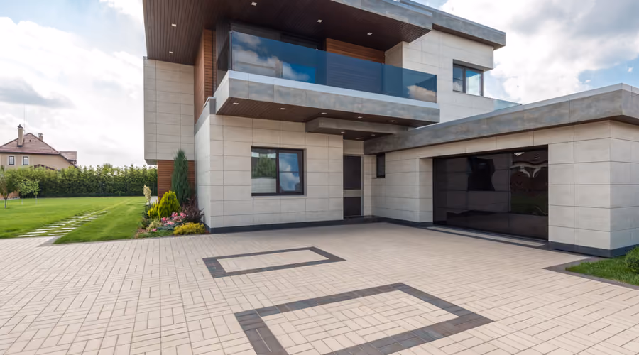 Newly completed custom home exterior with stone and timber accents under a Montana sky