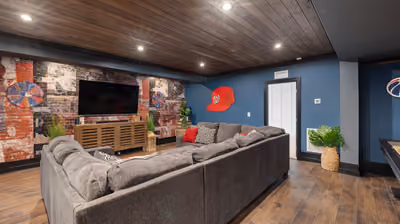 Finished basement family room with sofa seating and carpeted flooring