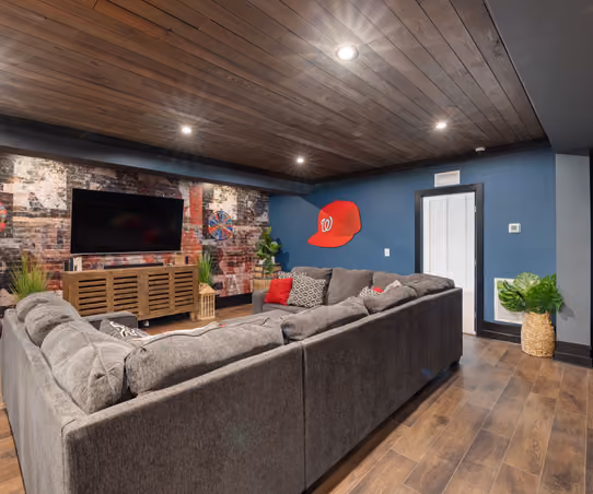 Finished basement family room with sofa seating and carpeted flooring