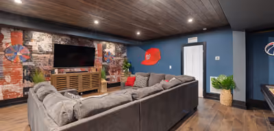 Finished basement family room with sofa seating and carpeted flooring
