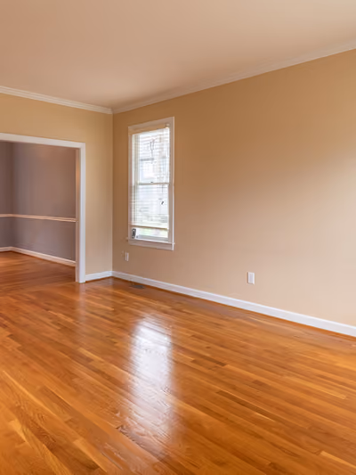 Bright room with newly installed glossy honey-oak hardwood flooring