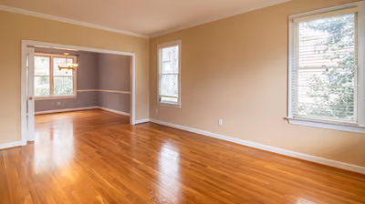 Room with newly installed glossy honey-oak hardwood flooring