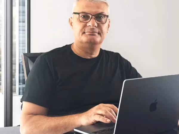 Gayk Martirosyan, Founder & General Contractor of Remodeling Montana, working at a laptop