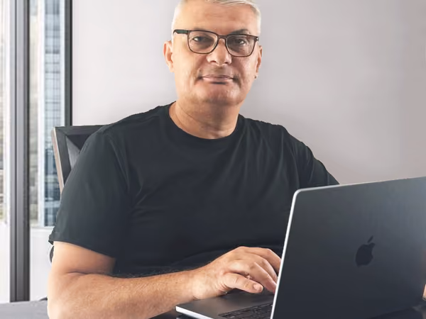 Gayk Martirosyan, Founder & General Contractor of Remodeling Montana, working at a laptop