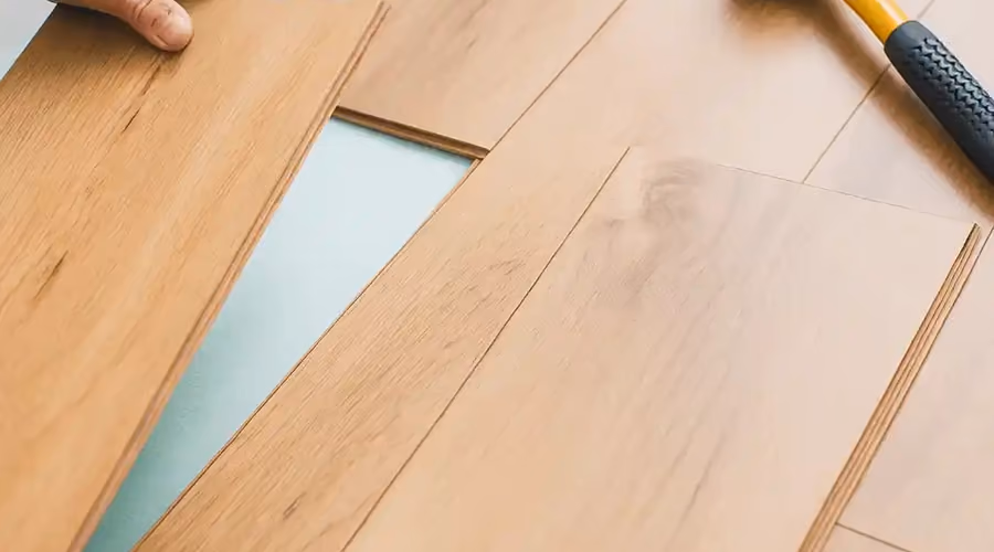 Hardwood flooring installation in progress with new honey-oak boards